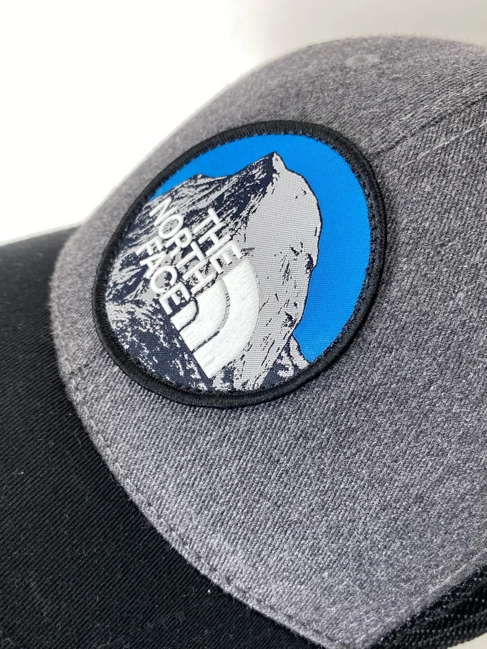 The North Face Grey & Black Patch Trucker Hat with Blue Accent Snap Back Unisex